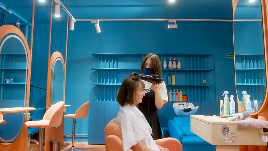 Stylist blow-drying a client's hair